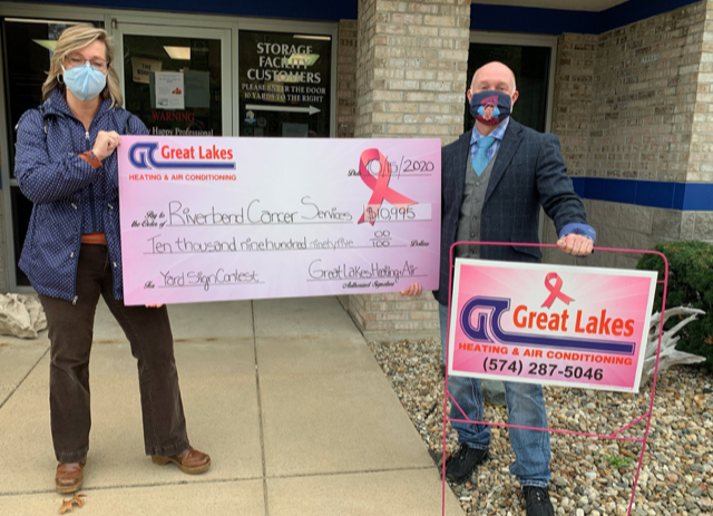 A check to Riverbend Cancer Services from Great Lakes Heating & Air Conditioning raised during the yard sign contest